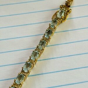 Light blue topaz and cz 7 1/4” bracelet in yellow gold plated sterling silver